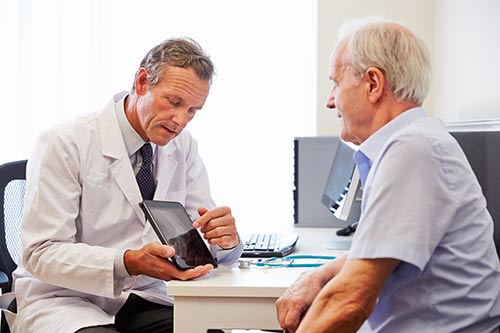 This image shows a senior patient and his doctor.