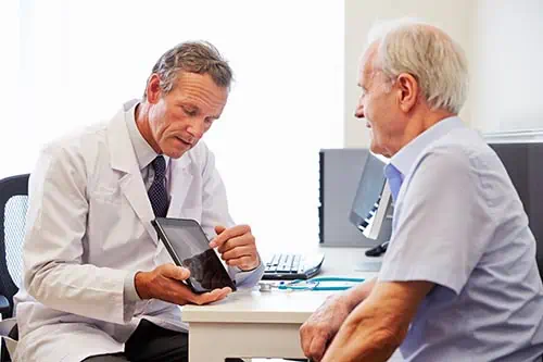 This image shows a senior patient and his doctor.