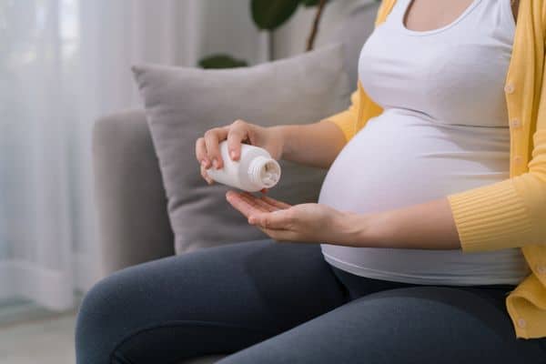 young woman taking Tylenol while pregnant