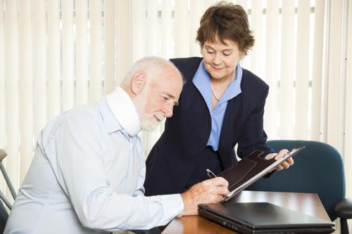 An attorney reviewing an injury settlement offer with a client.