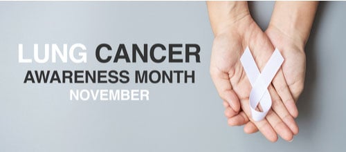 November Lung Cancer Awareness month. Hands holding white Ribbon on grey background