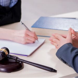 Image is of a lawyer consulting client about the damages awarded from an oklahoma paraquat lawsuit