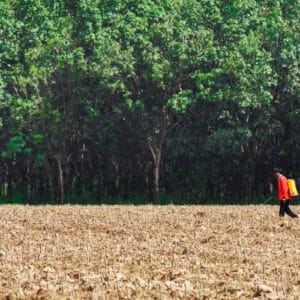 Image is of man spraying paraquat on a field - kansas paraquat lawsuit